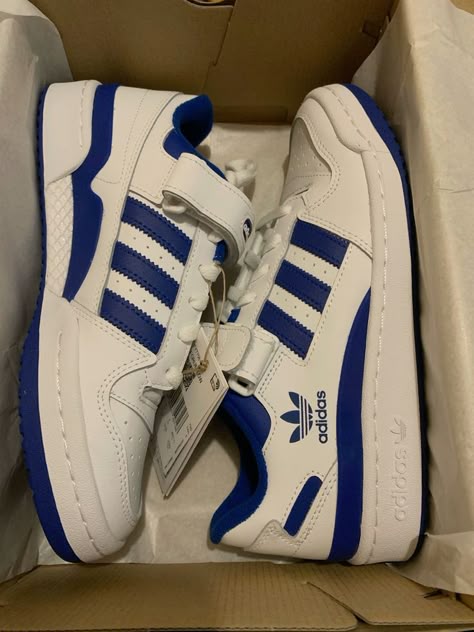 Side profile of the Adidas Forum Low Blue and White, highlighting its bold blue overlays, Three Stripes branding, and cushioned midsole.