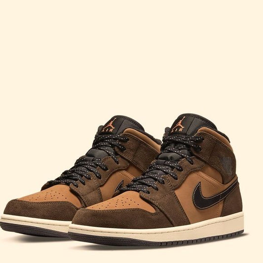 Close-up of the Air Jordan 1 "Dark Chocolate," showcasing its brown suede upper, black leather accents, and perforated toe box.