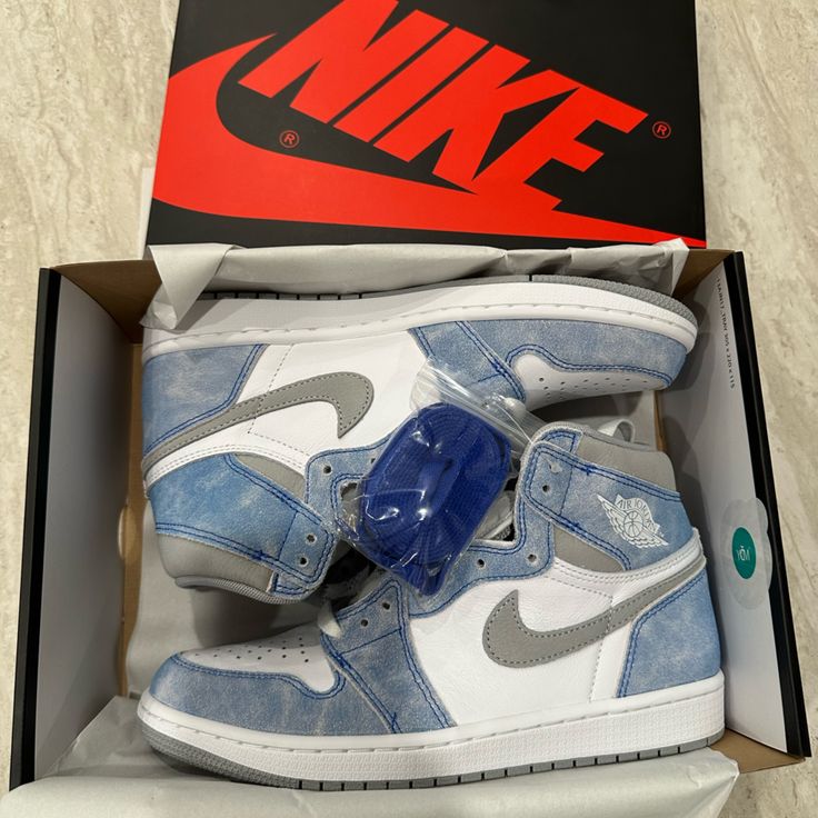 Side profile of the Air Jordan 1 "Hyper Royal," highlighting its faded blue detailing, iconic Nike Swoosh, and high-top silhouette.