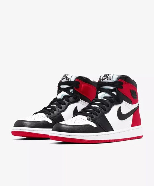 Close-up of the Jordan 1 Retro High Satin 'Black Toe,' showcasing its premium leather upper, satin heel, and bold black, white, and red design.