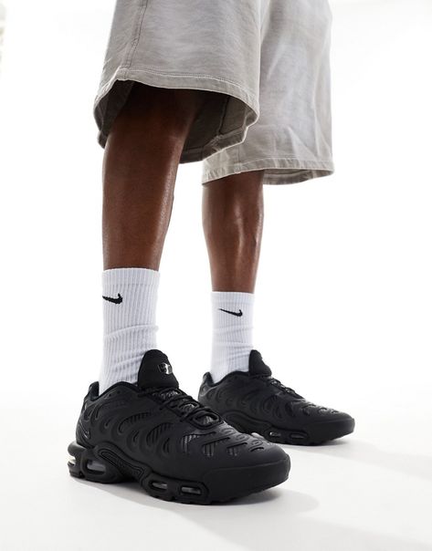 Nike Air Max Plus Black worn on feet, emphasizing its streetwear appeal, comfort, and high-performance build.