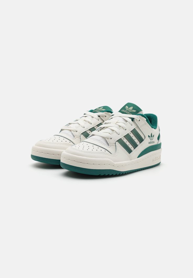 Close-up of the Adidas Forum Low Green and White, showcasing its smooth leather upper, perforated toe box, and classic Velcro strap.

