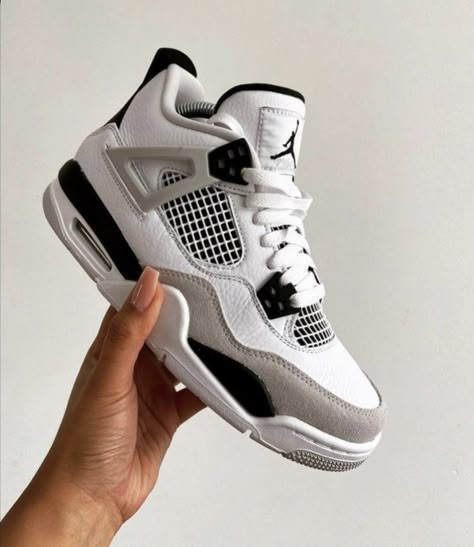 Side profile of the Air Jordan 4 White and Black (Retro Military Black), highlighting its black midsole, Jumpman logo, and sleek design.

