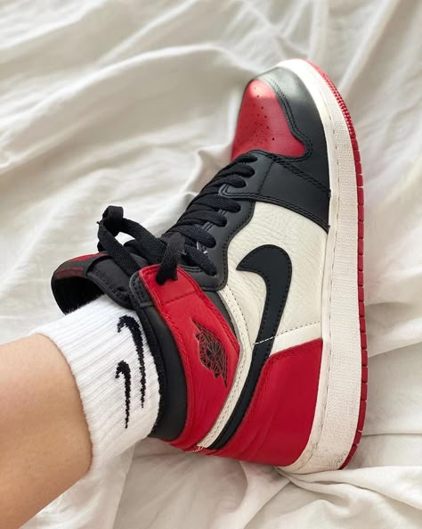 Jordan 1 Retro High Satin 'Black Toe' worn on feet, emphasizing its stylish contrast, premium materials, and timeless appeal.

